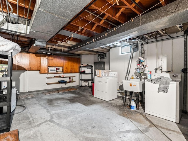 basement featuring separate washer and dryer and sink