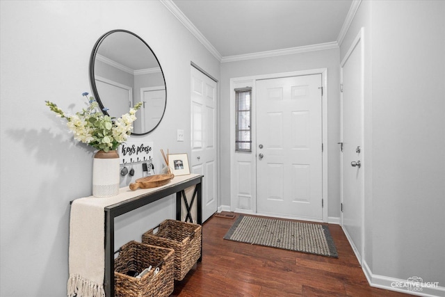 foyer entrance with baseboards, ornamental molding, and wood finished floors