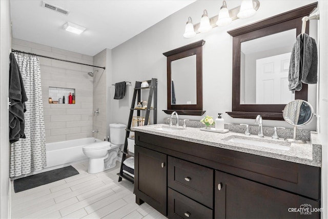 full bathroom featuring toilet, a sink, visible vents, and shower / bathtub combination with curtain