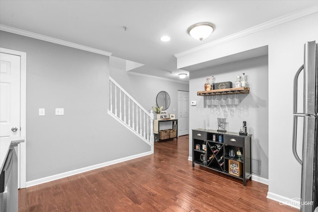 interior space with stairway, ornamental molding, wood finished floors, and freestanding refrigerator