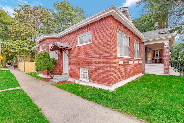 view of property exterior with a lawn