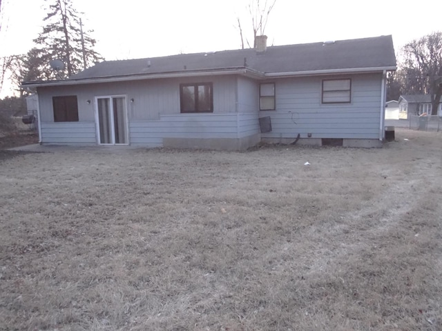 rear view of house featuring a chimney