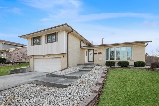 split level home with a garage, brick siding, driveway, and a front lawn