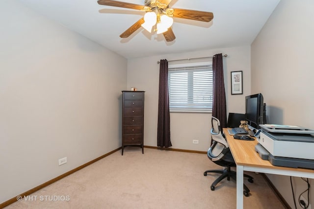 office with a ceiling fan, light carpet, and baseboards