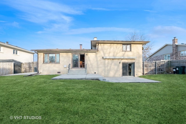 back of property featuring a chimney, a lawn, crawl space, a patio area, and a fenced backyard