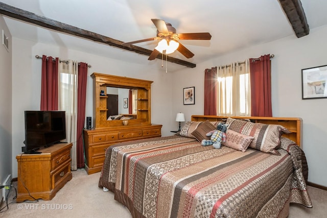 bedroom featuring visible vents, beamed ceiling, a ceiling fan, and light colored carpet