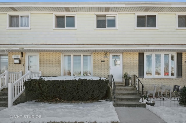 townhome / multi-family property with brick siding