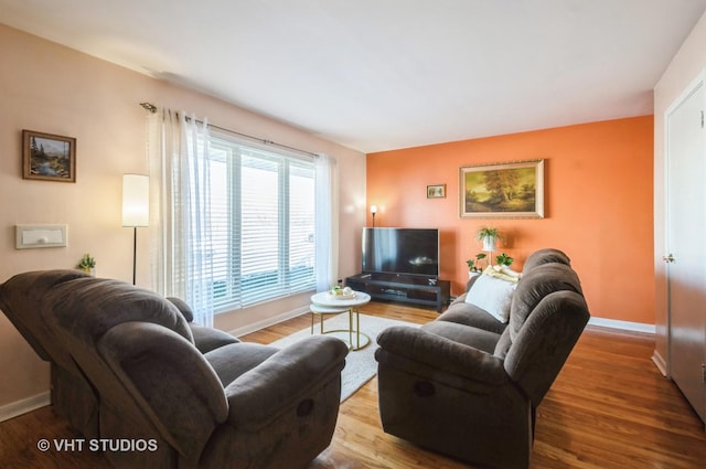 living area with light wood-style floors and baseboards