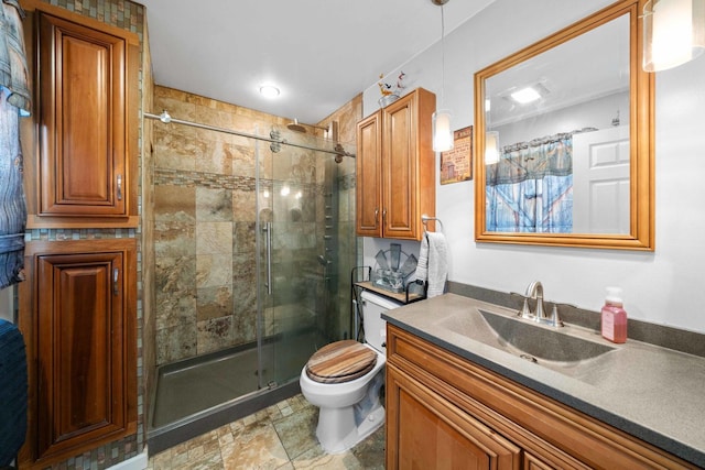 bathroom featuring vanity, toilet, and an enclosed shower