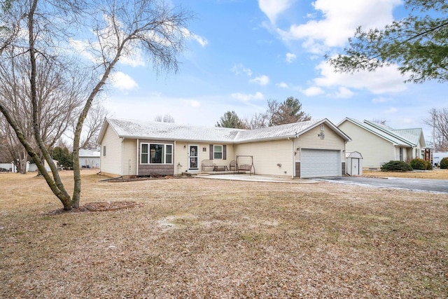 ranch-style home with a garage and a front yard