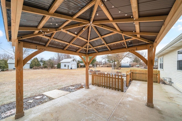 view of patio / terrace with a gazebo and an outbuilding