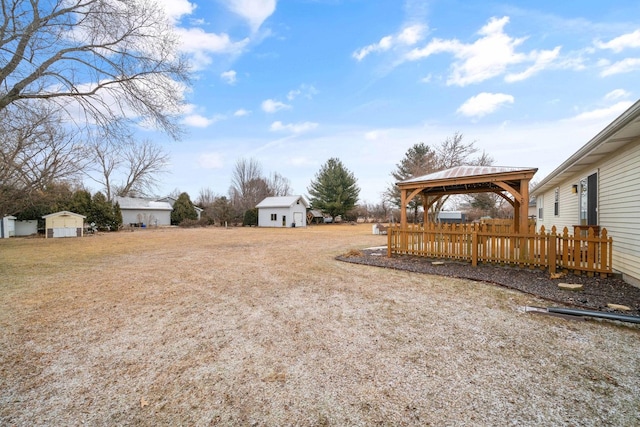 view of yard featuring a gazebo and a storage shed