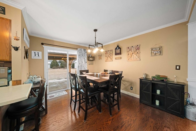 dining room with an inviting chandelier, ornamental molding, and dark hardwood / wood-style floors