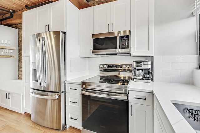 kitchen with white cabinetry and stainless steel appliances