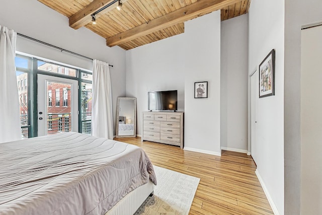 bedroom with lofted ceiling with beams, light hardwood / wood-style flooring, wooden ceiling, track lighting, and access to exterior