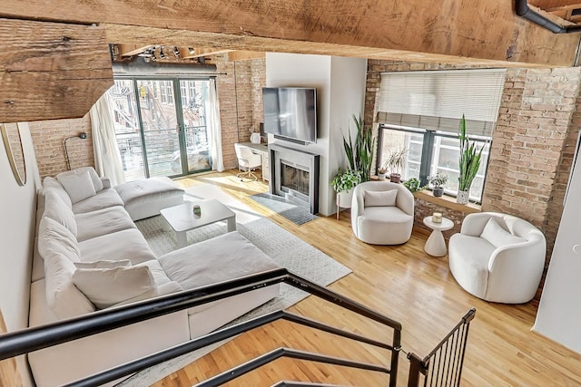 living room featuring light hardwood / wood-style floors and brick wall