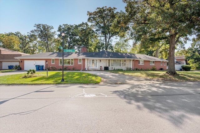 single story home featuring a front lawn and central air condition unit