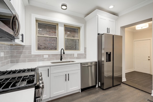 kitchen featuring crown molding, appliances with stainless steel finishes, sink, and white cabinets