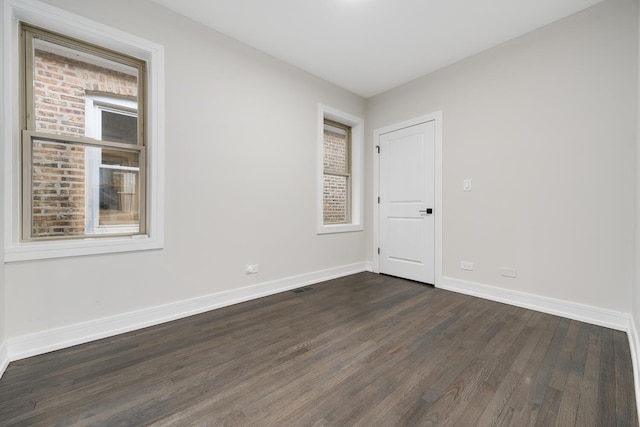 spare room featuring dark hardwood / wood-style flooring