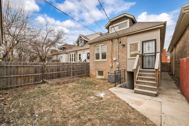 back of property featuring central AC unit