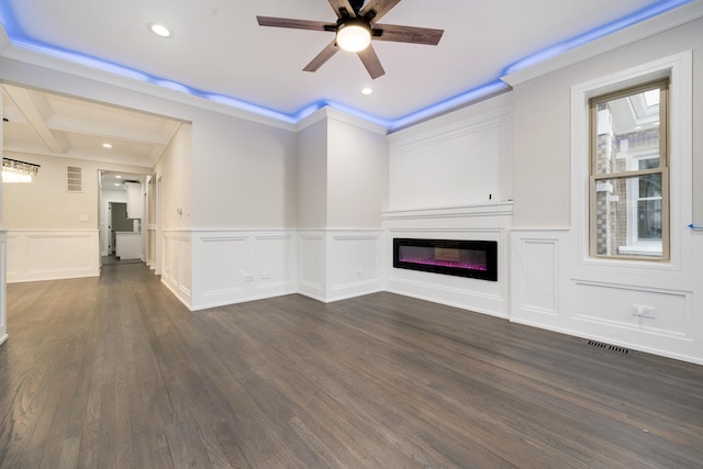 unfurnished living room with crown molding, dark wood-type flooring, and ceiling fan