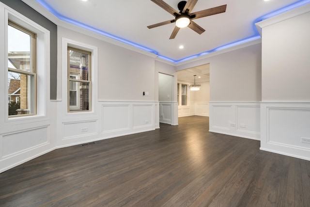 spare room featuring crown molding, ceiling fan, and dark hardwood / wood-style flooring