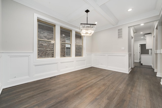 unfurnished dining area featuring coffered ceiling, ornamental molding, dark hardwood / wood-style floors, a notable chandelier, and beam ceiling