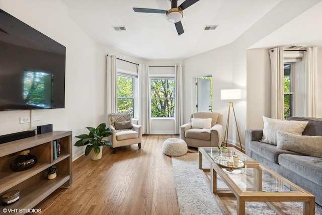 living room featuring hardwood / wood-style floors and ceiling fan