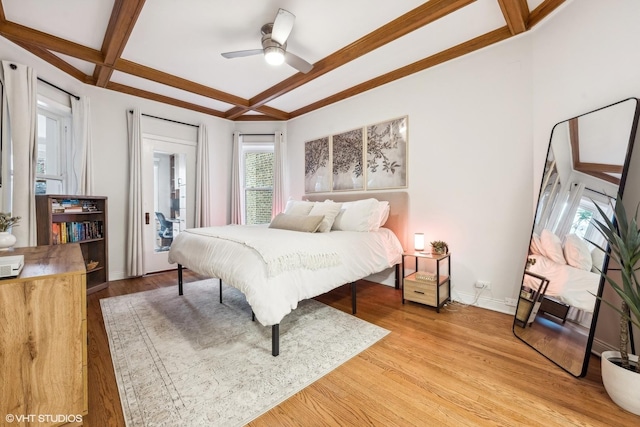 bedroom with coffered ceiling, ceiling fan, light hardwood / wood-style floors, and beamed ceiling