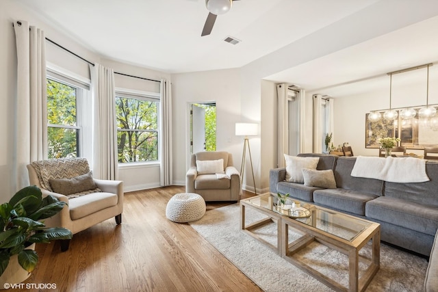 living room featuring ceiling fan and wood-type flooring