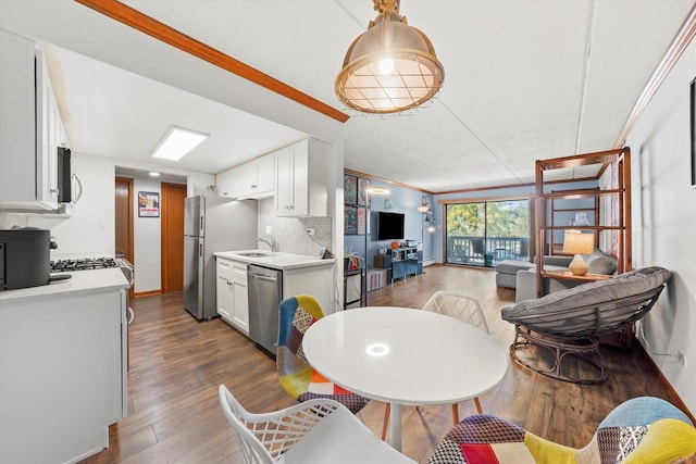 dining space featuring sink, crown molding, and dark hardwood / wood-style floors