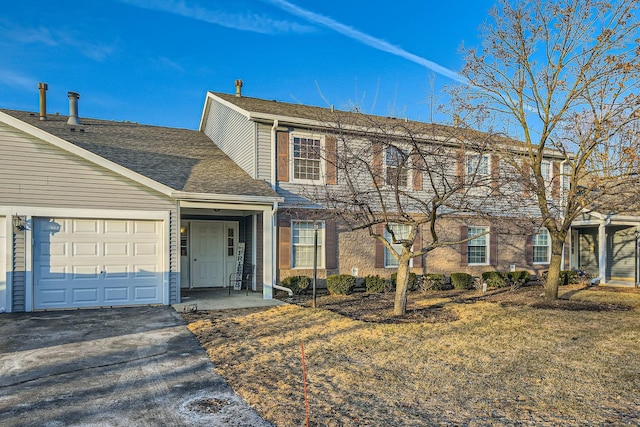 front facade featuring a garage and a front lawn