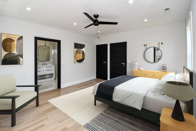 bedroom with ceiling fan, sink, and light wood-type flooring