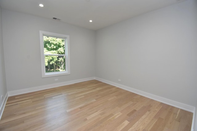 spare room featuring light hardwood / wood-style flooring