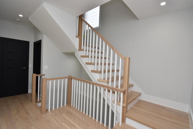 stairs with hardwood / wood-style flooring