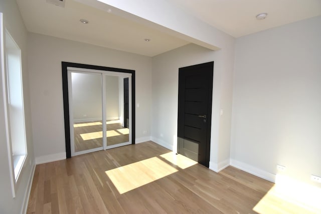 spare room with light wood-type flooring