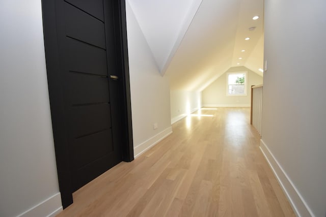 bonus room featuring lofted ceiling and light hardwood / wood-style floors