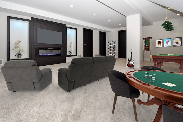 playroom with light carpet, pool table, and a large fireplace