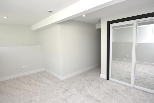 unfurnished bedroom with light colored carpet