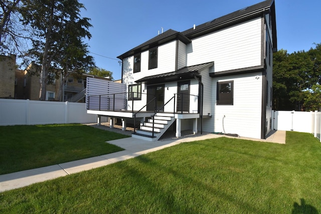 rear view of house with a lawn