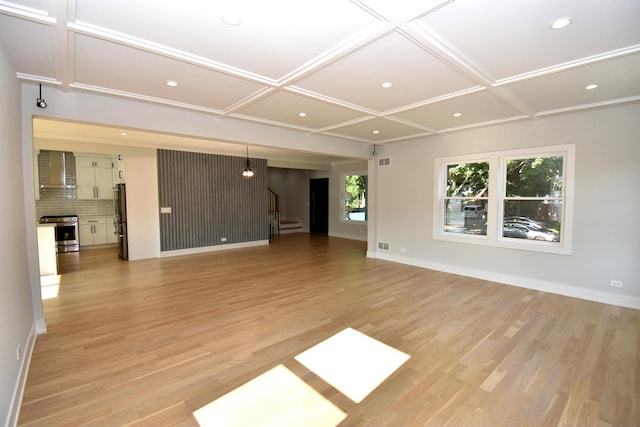 unfurnished living room with coffered ceiling and light hardwood / wood-style floors