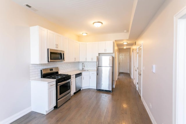 kitchen featuring a sink, visible vents, white cabinetry, light countertops, and appliances with stainless steel finishes