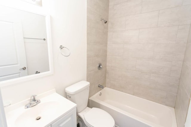 bathroom featuring toilet, bathing tub / shower combination, and vanity