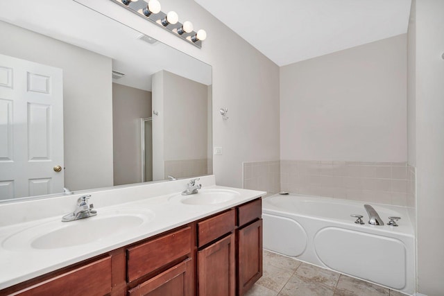 bathroom with vanity and independent shower and bath