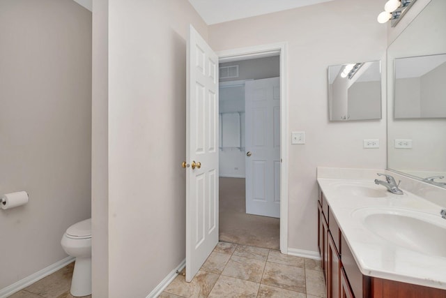 bathroom featuring vanity and toilet