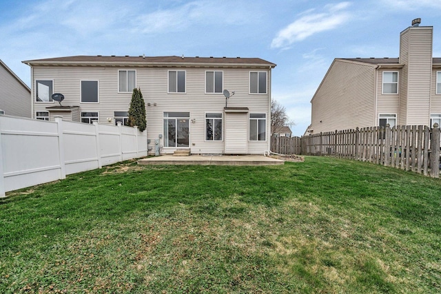 back of house featuring a yard and a patio