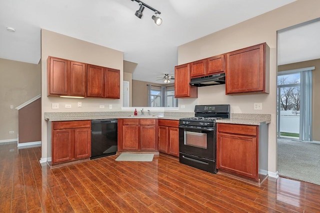 kitchen featuring sink, rail lighting, ceiling fan, black appliances, and dark hardwood / wood-style flooring