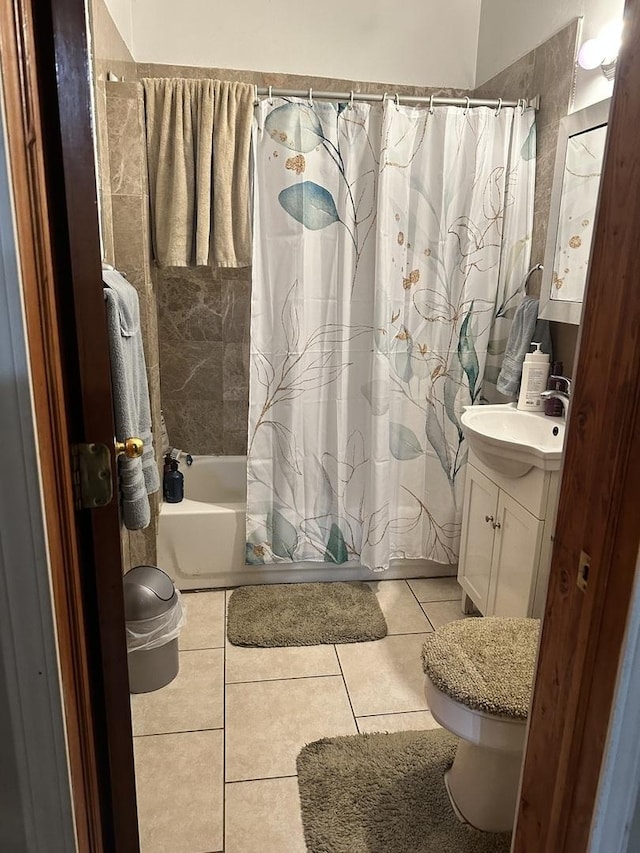 full bathroom with vanity, shower / tub combo with curtain, tile patterned floors, and toilet