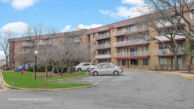 view of building exterior with uncovered parking