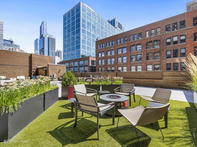 exterior space featuring a fire pit and a view of city